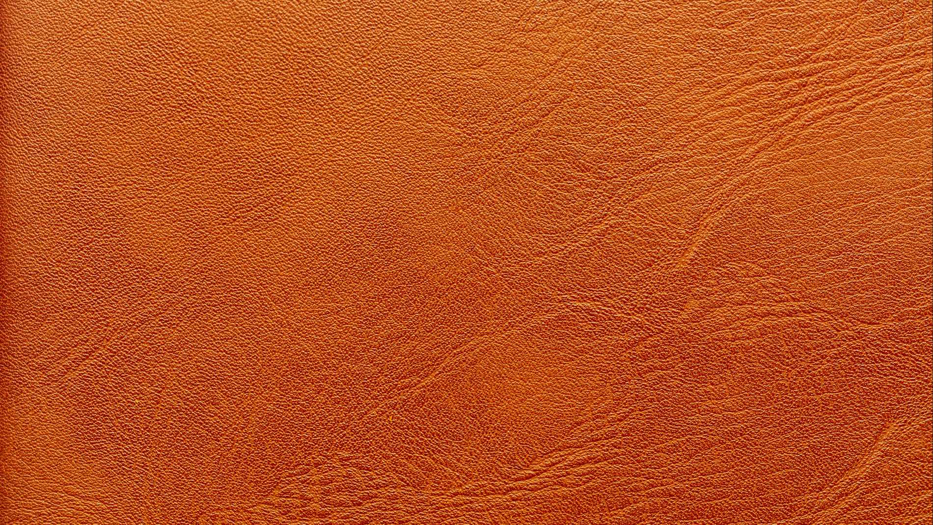 Close-up of a brown leather texture with fine grain, representing sustainable alternatives to animal leather.