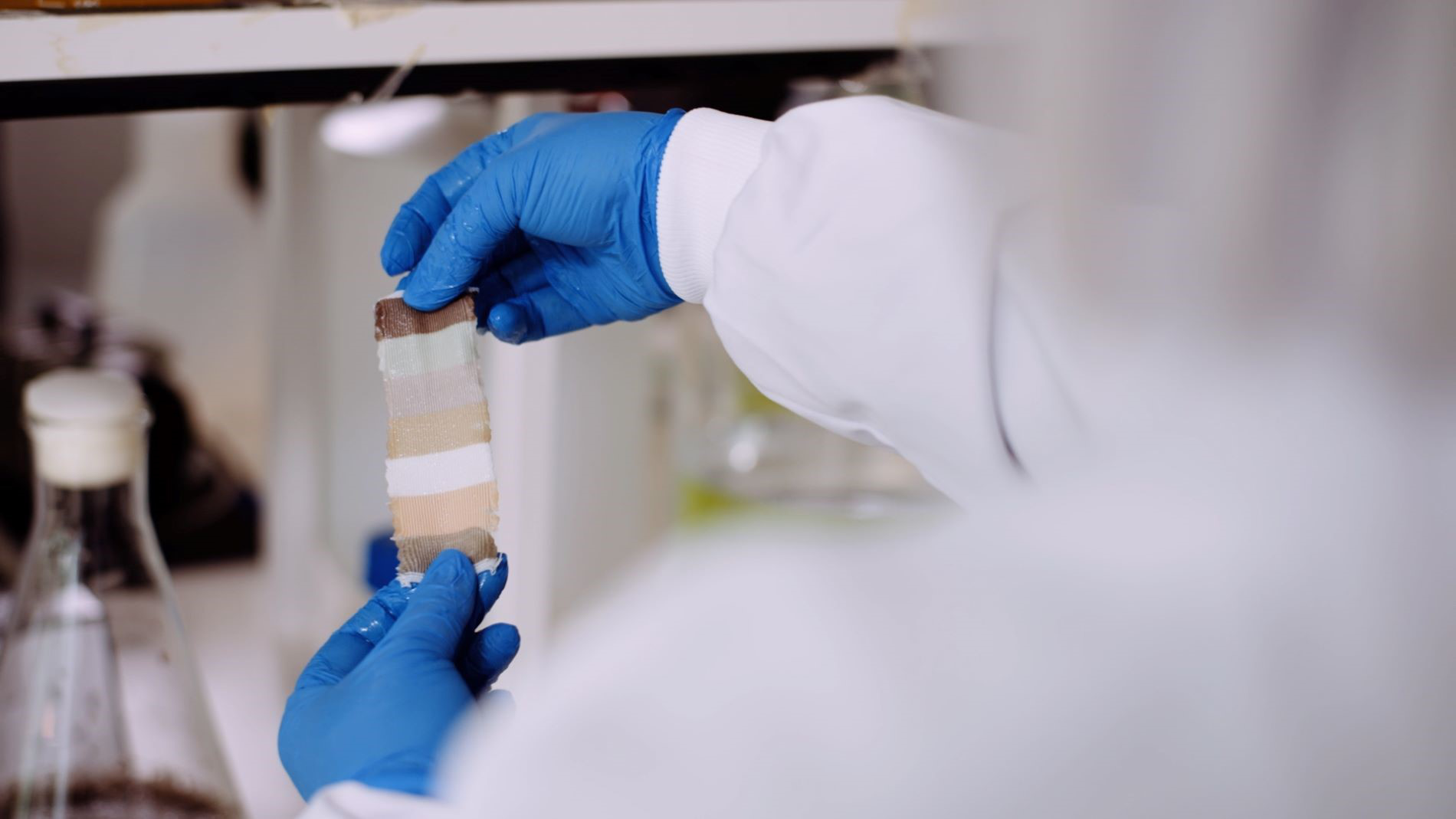 Laboratory employee holds colour result