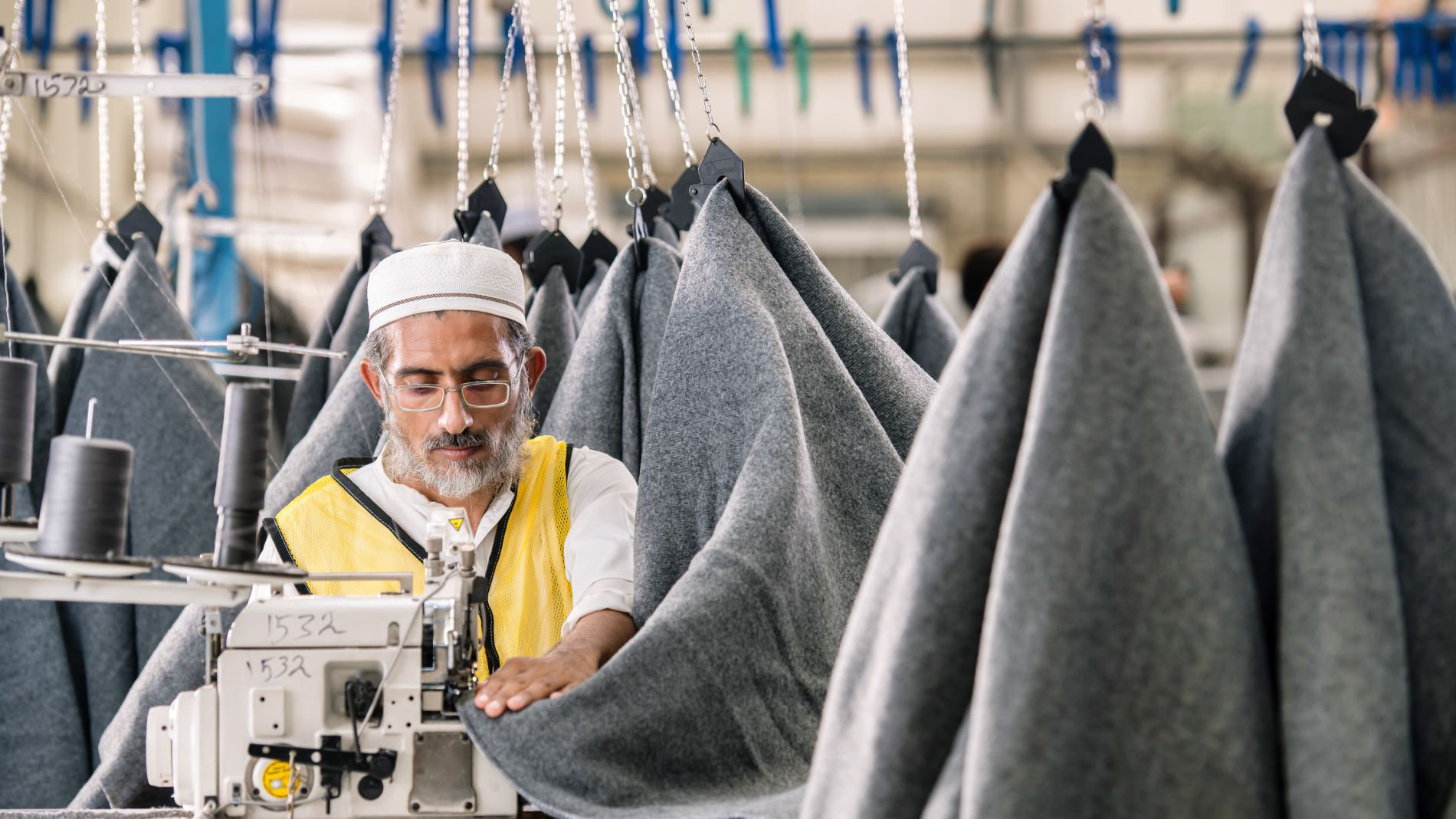 H. Nizam between blankets for refugees