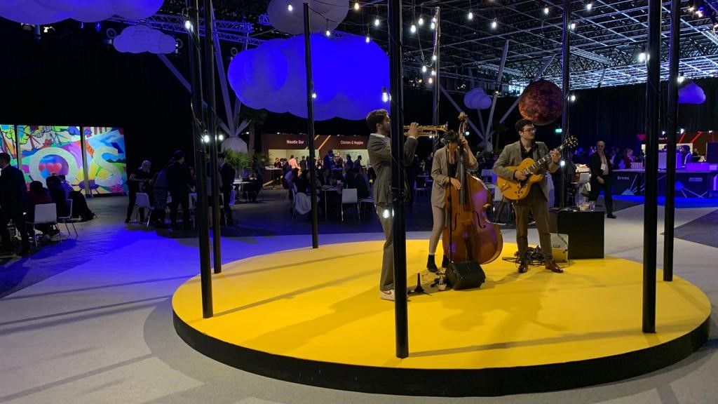 Circular stage with musicians at a trade fair