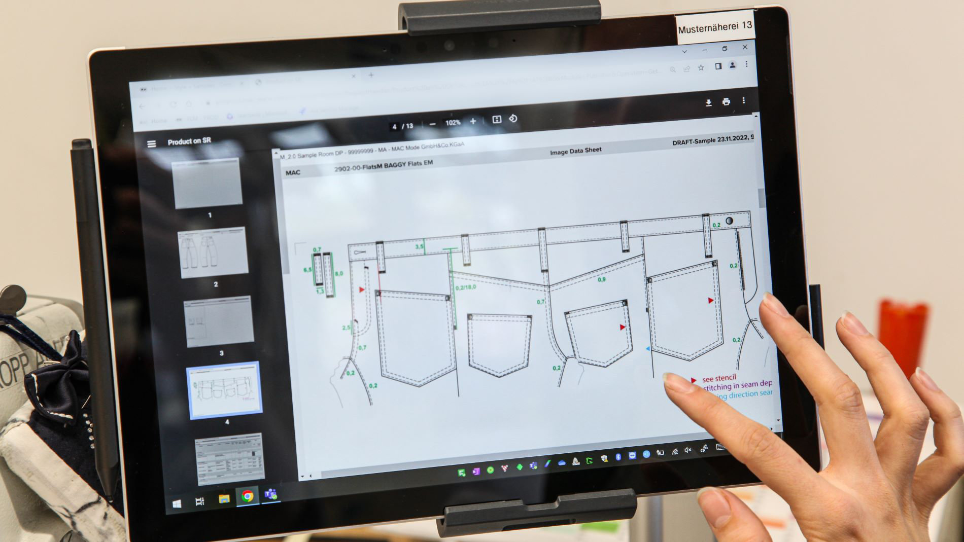 Digital patterns for jeans design displayed on tablet in sample sewing room