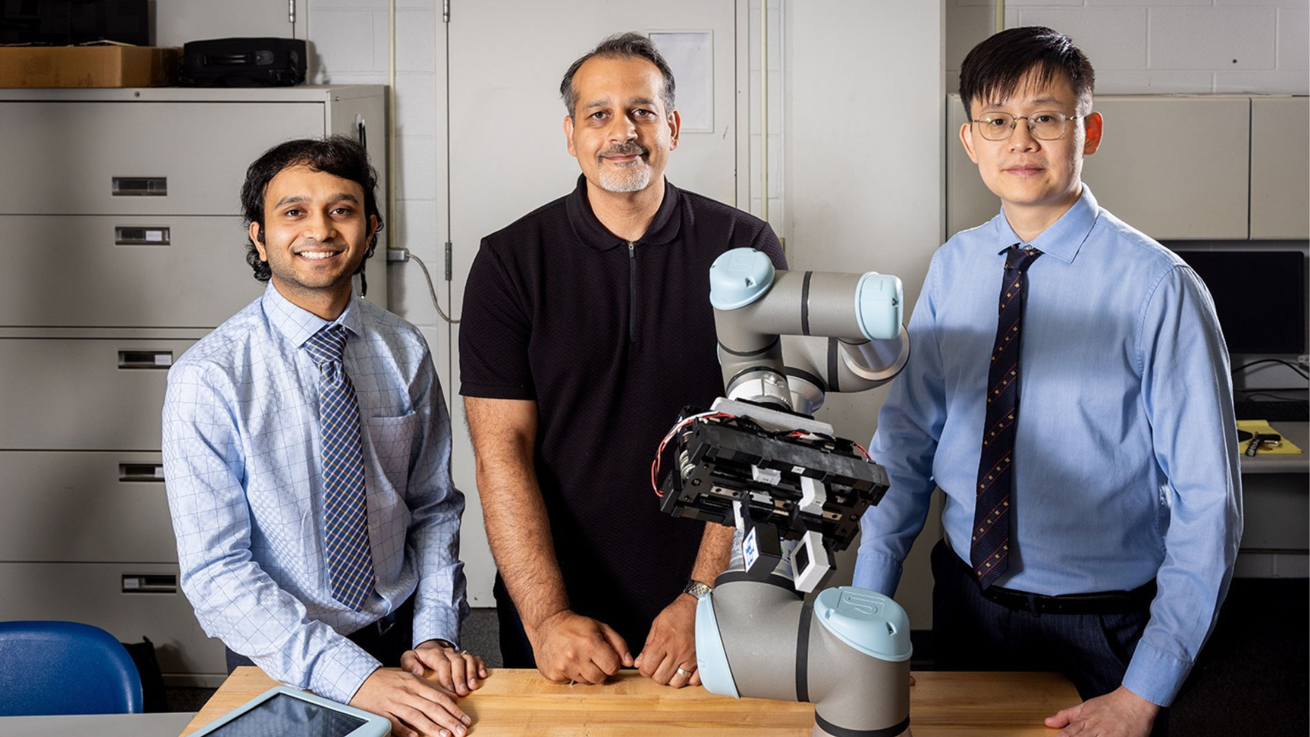 Vashin Gautham, Dr Ehsan Esfahani and Jun Liu in front of a robotic gripper