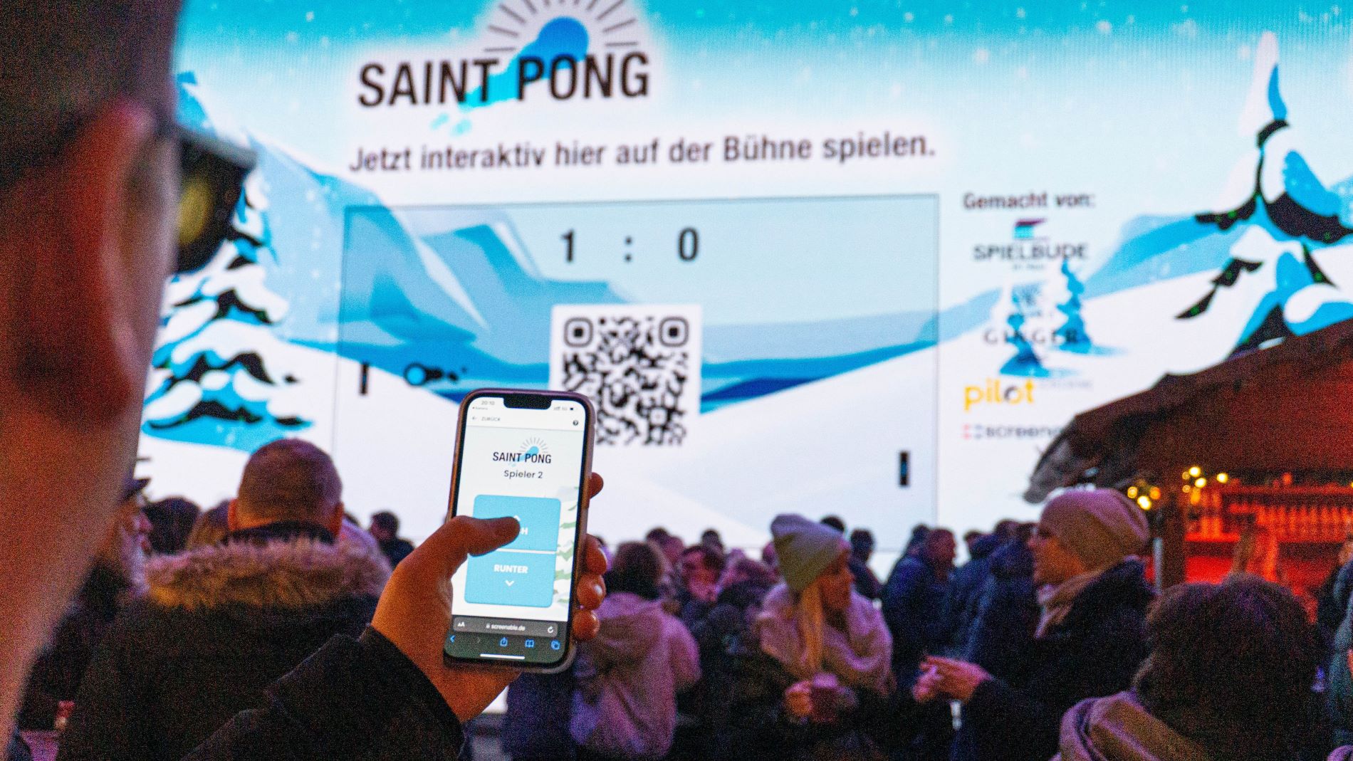 Mann scant QR Code für Gamification auf einem Weihnachtsmarkt