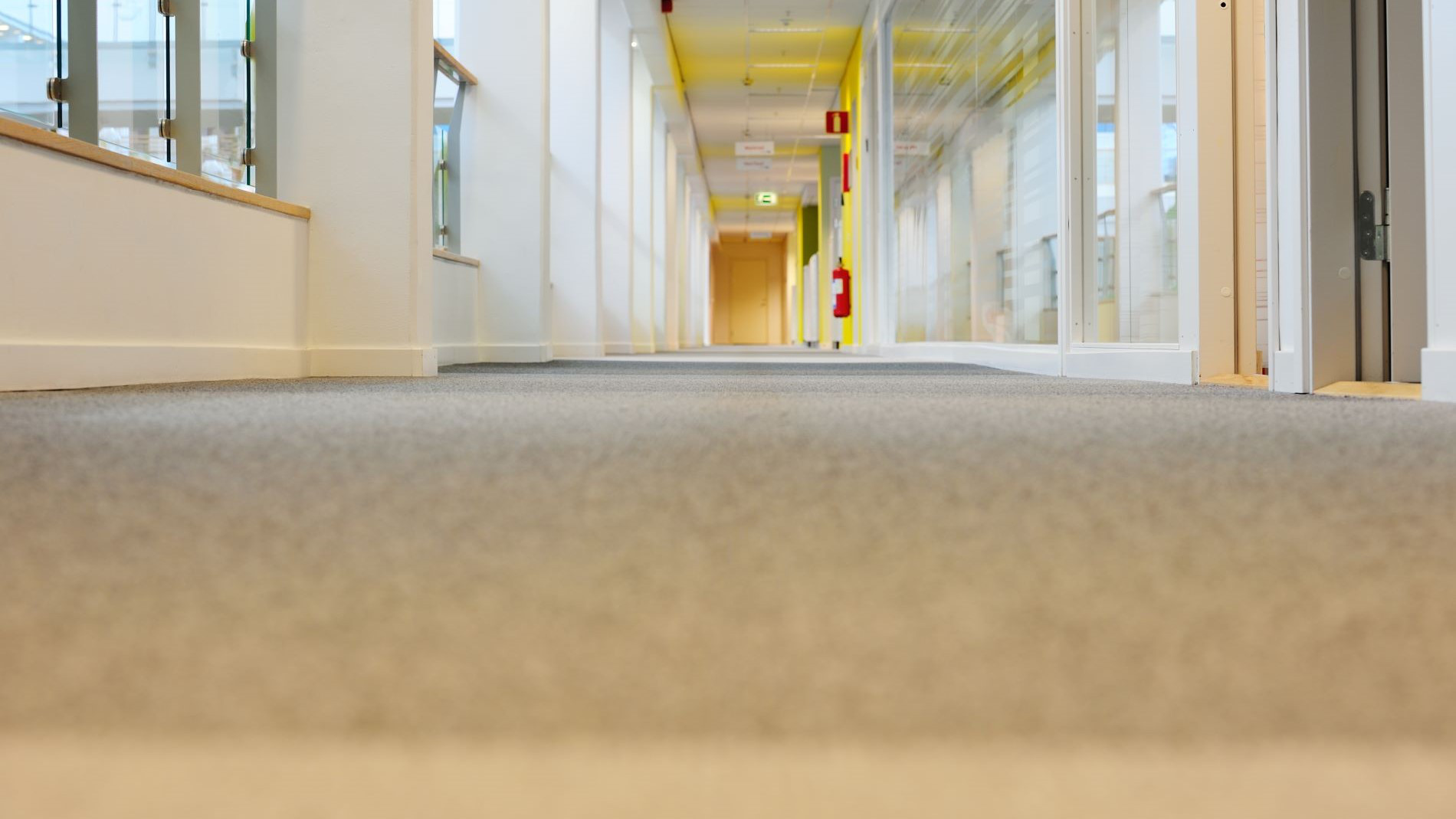 Three people are standing in a conference room