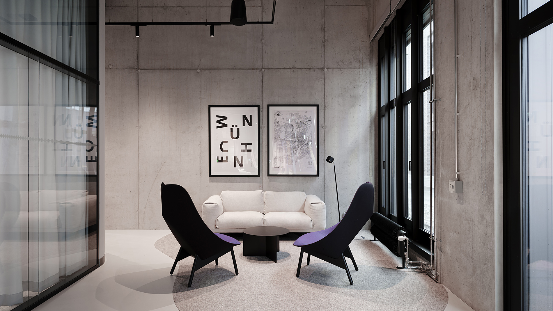 Small lounge area with minimalist design, large windows, and comfortable seating