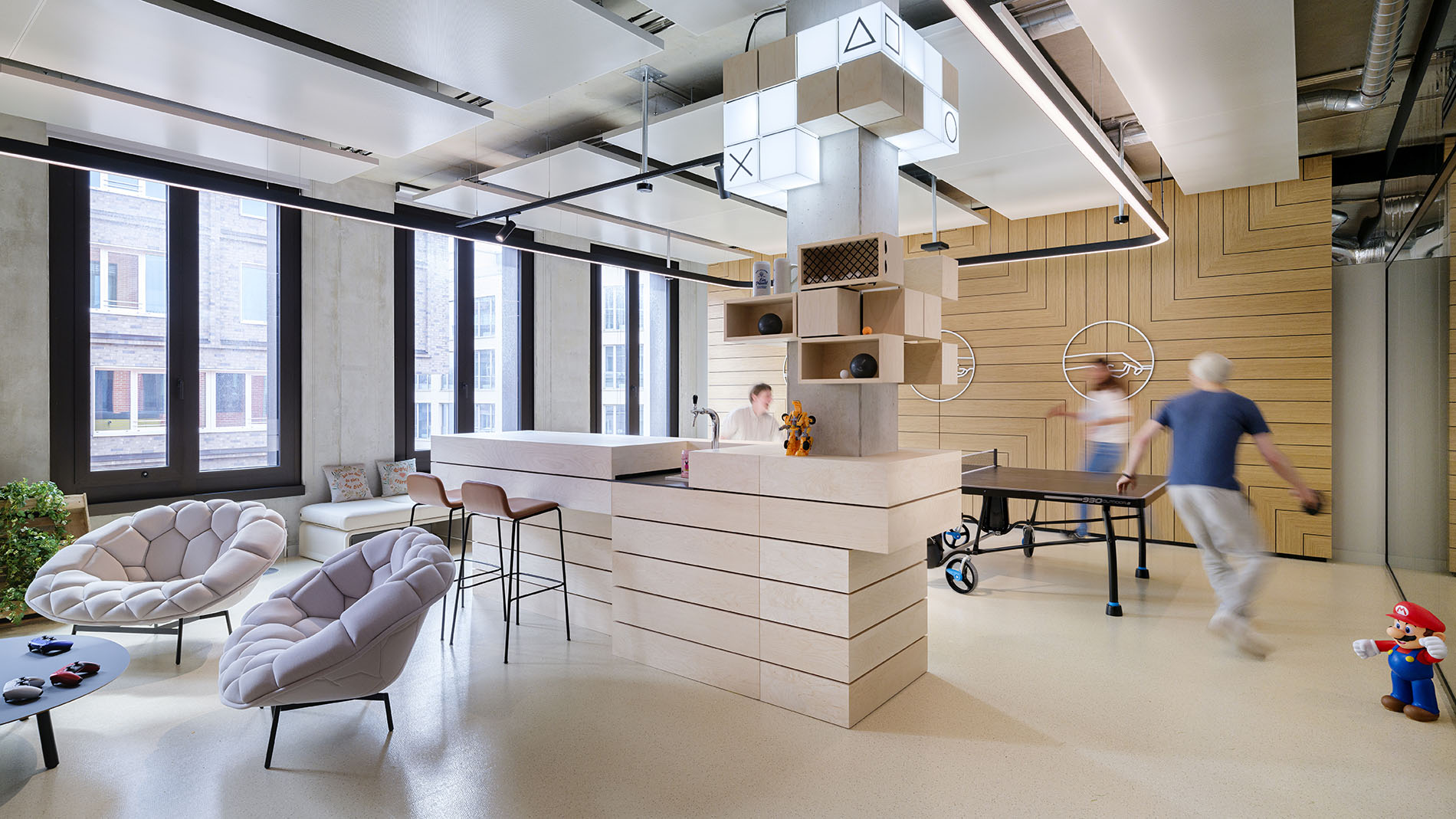 Recreational lounge with ping-pong table, seating, and modern lighting