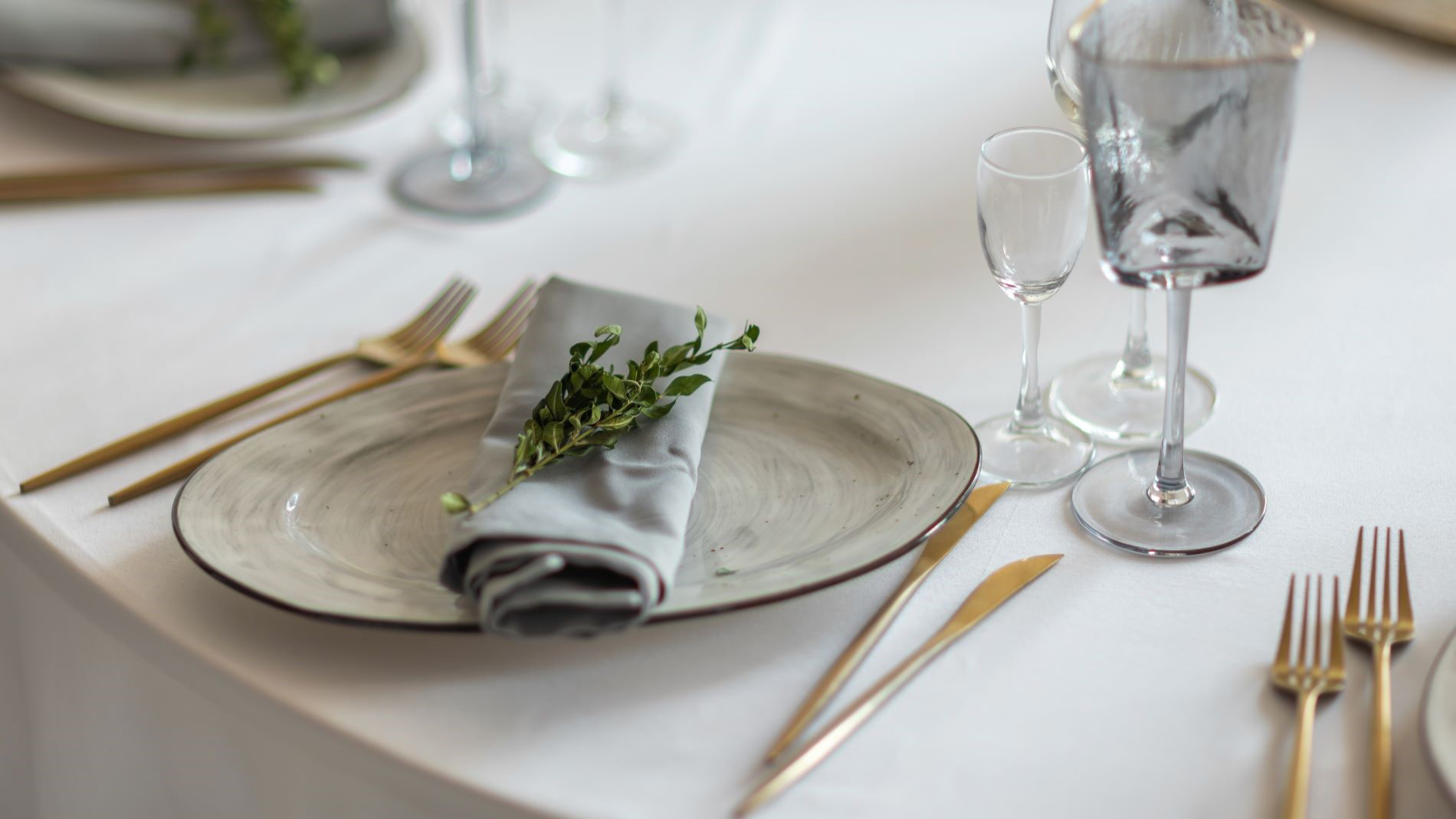Plates with cutlery and glasses on a table