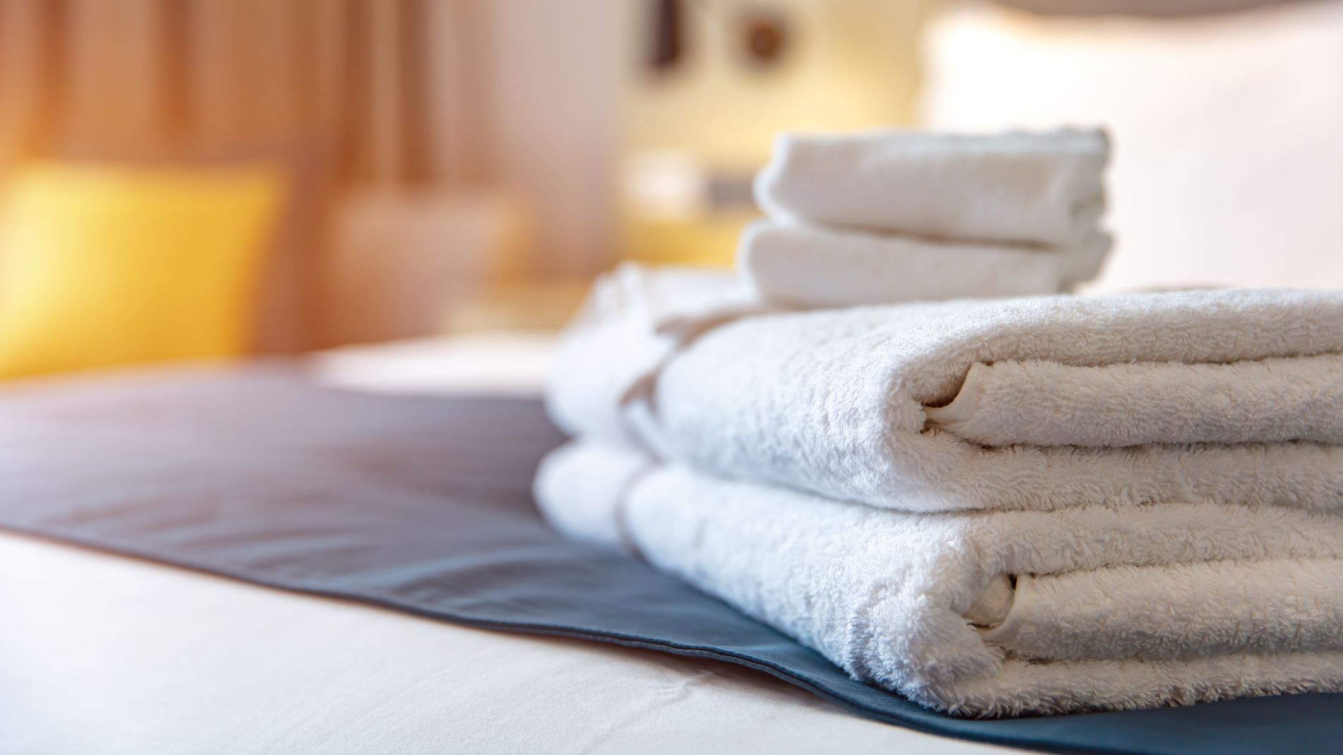 Stack towels on a hotel bed
