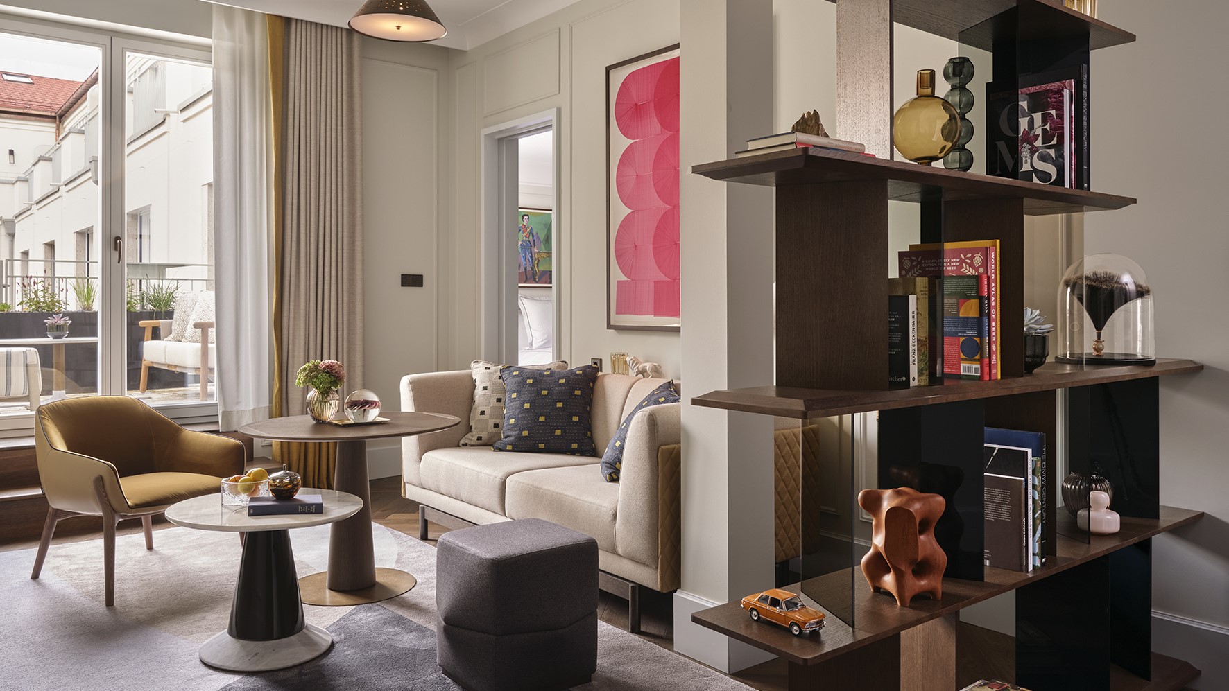 Modern living room with open shelving and art.