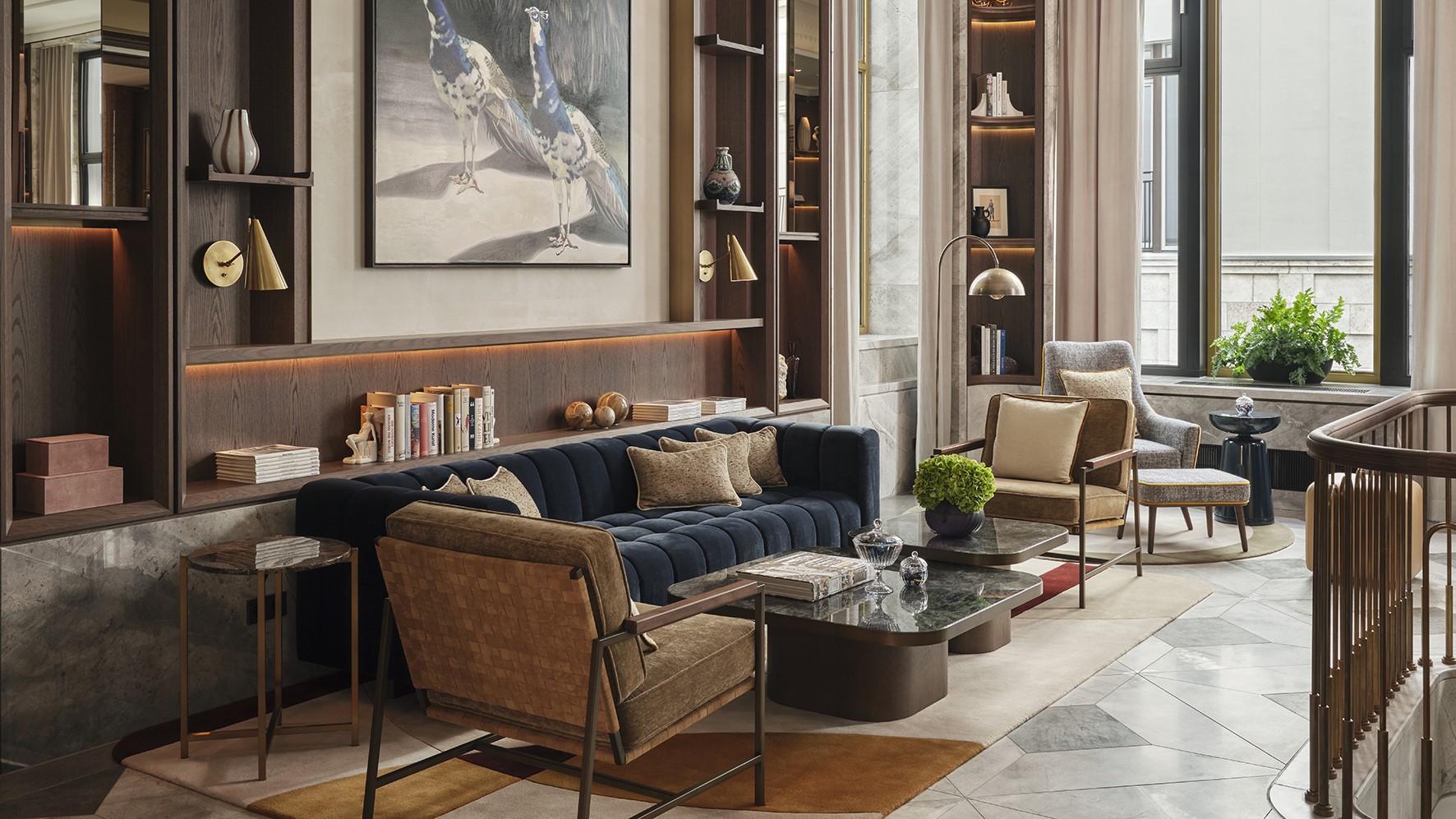 Stylish lobby with dark blue sofa and shelving.