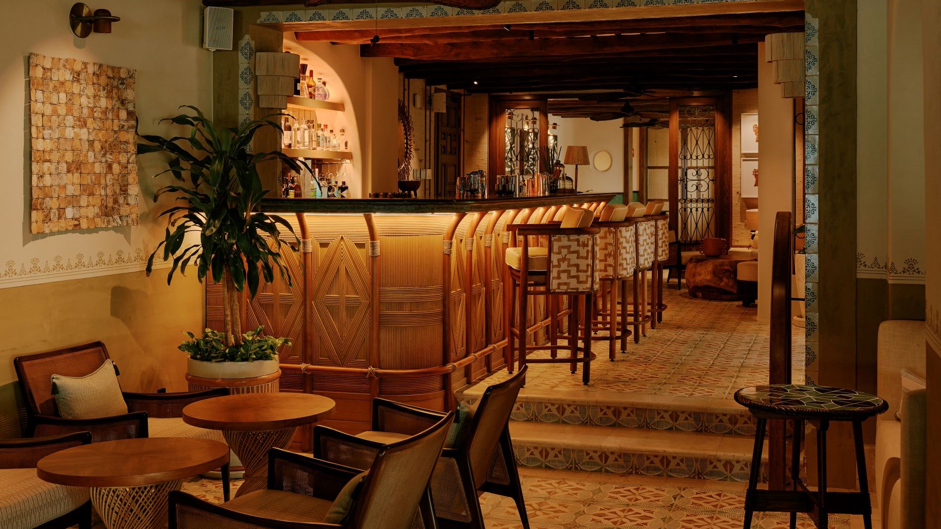 Warm bar lounge with wooden details and soft lighting.