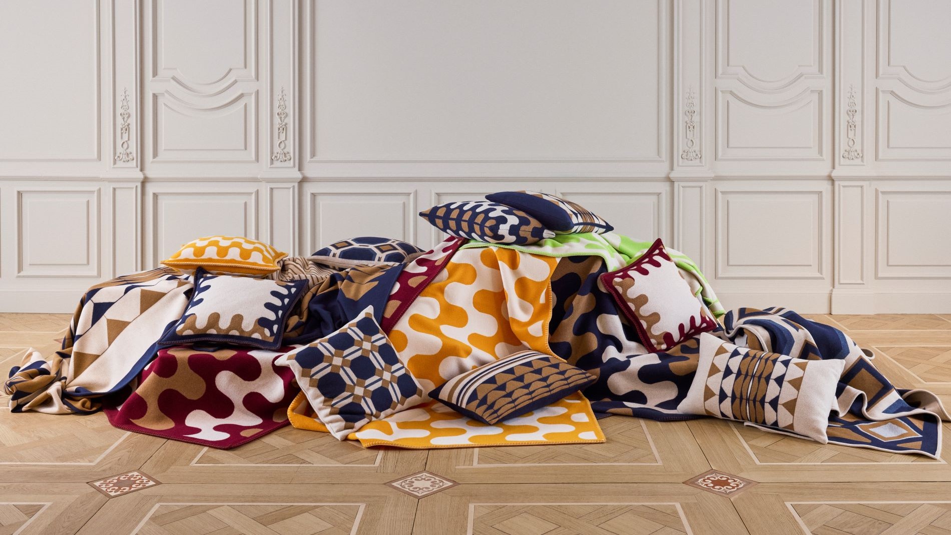 Colourful blankets and cushions artfully arranged.