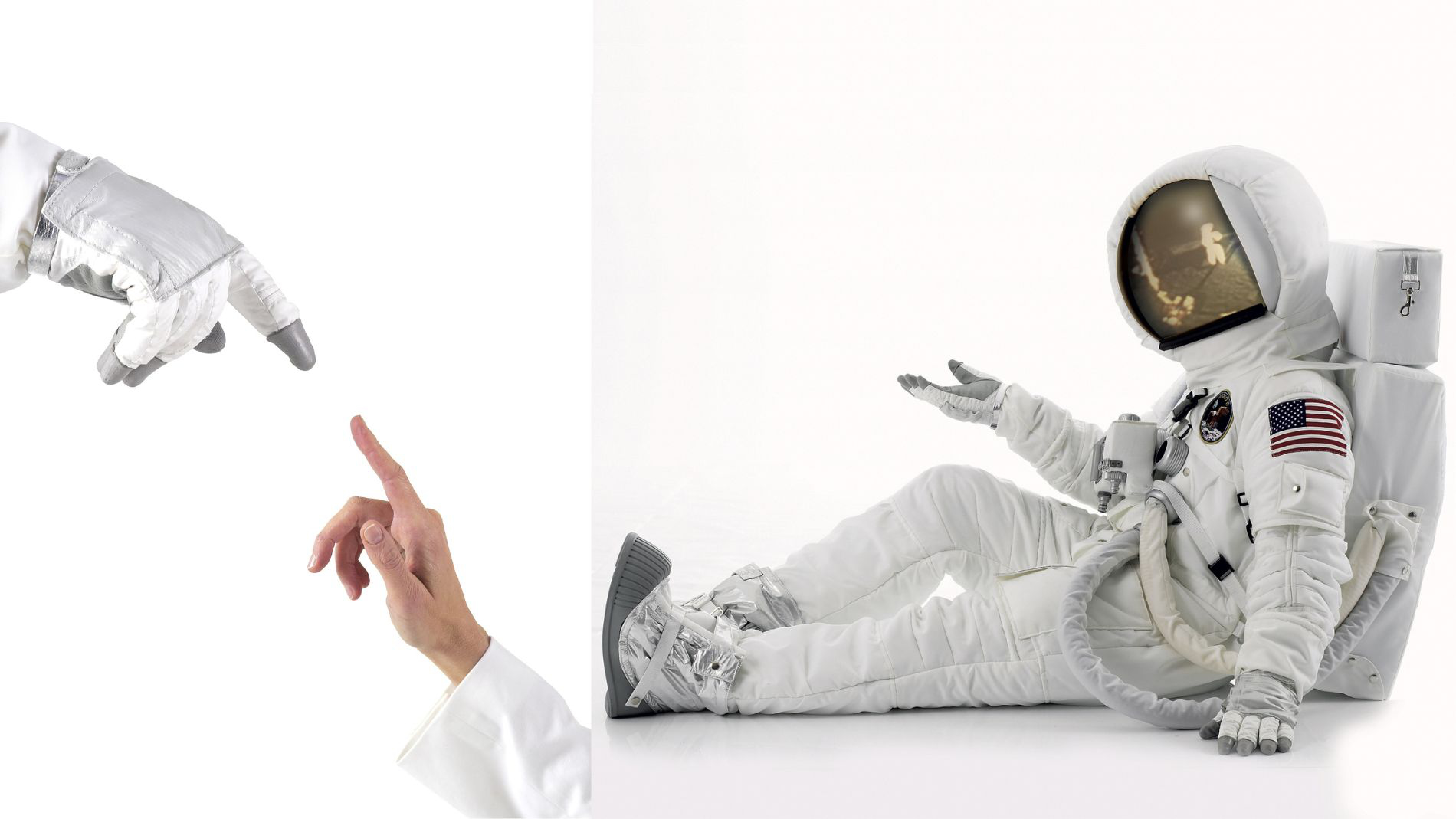 Astronaut and human hand shown together
