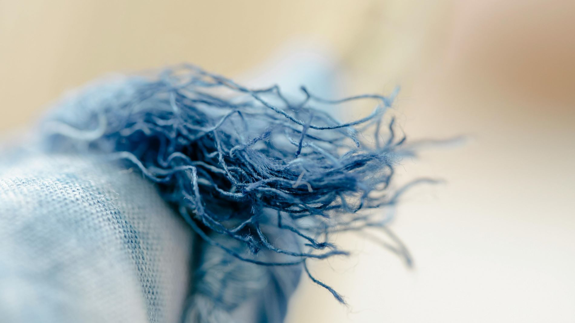 Frayed denim fibres in close-up