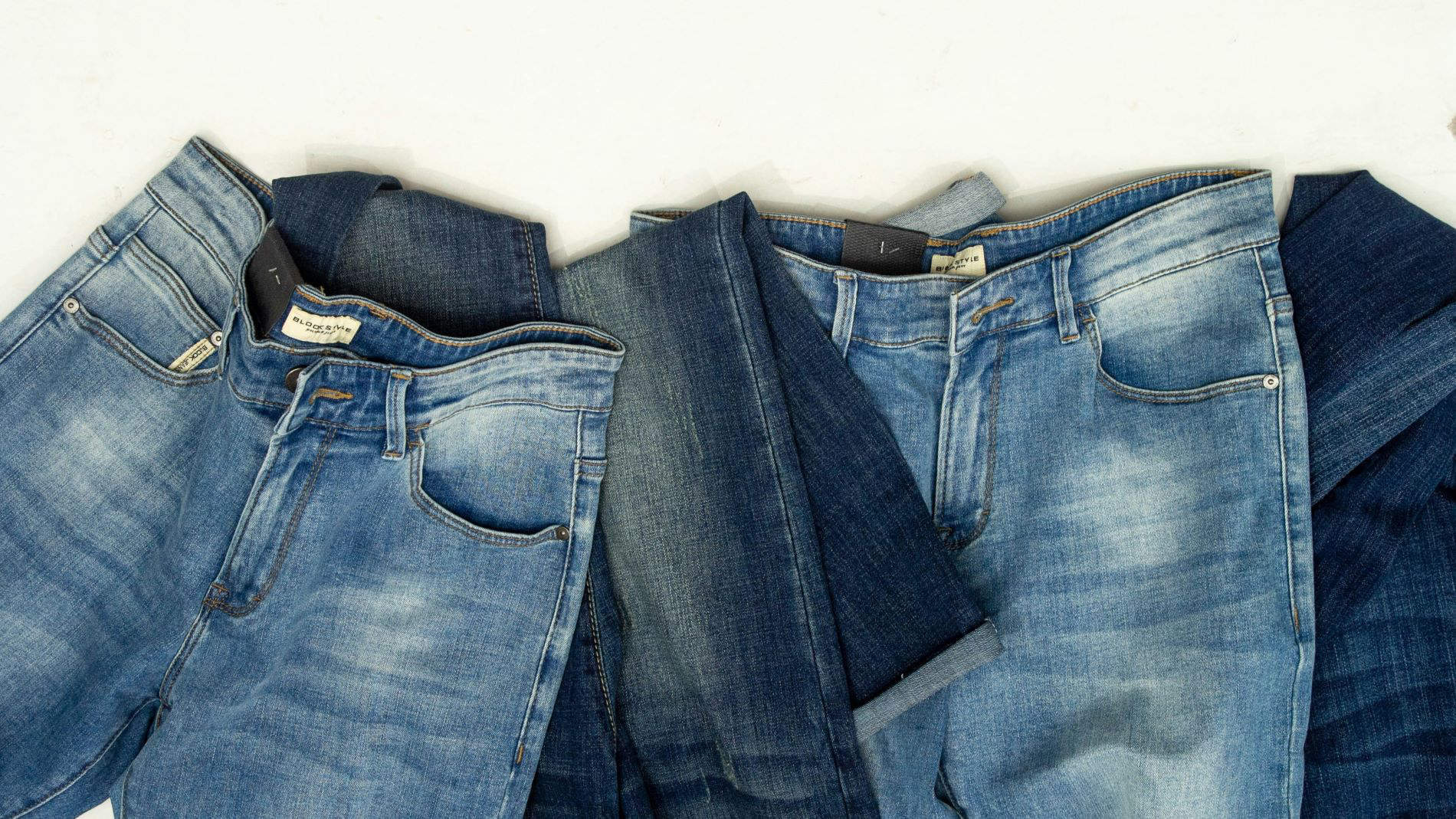 Multiple denim jeans in different blue shades
