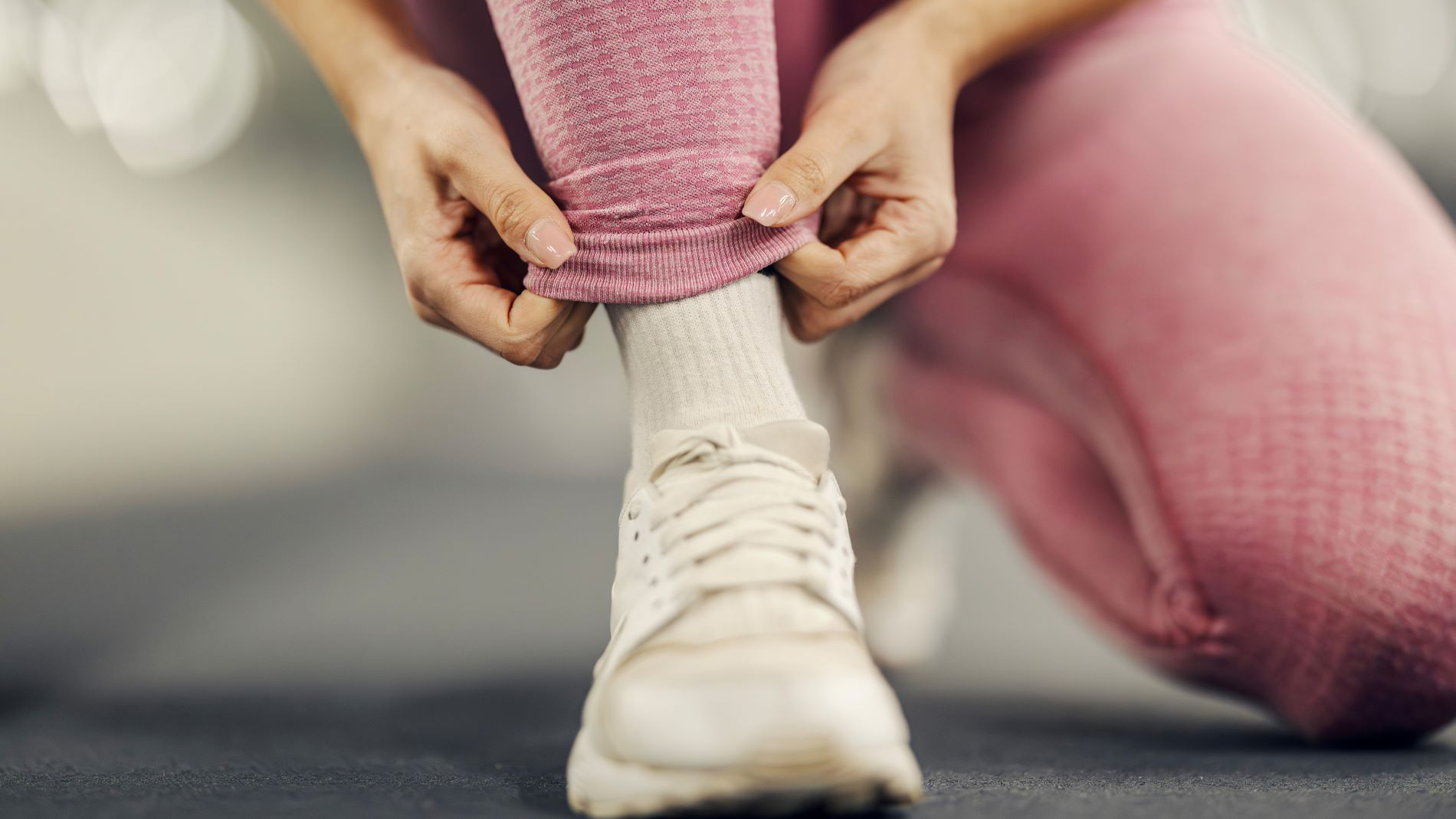 Athlete pulling socks over foot before training