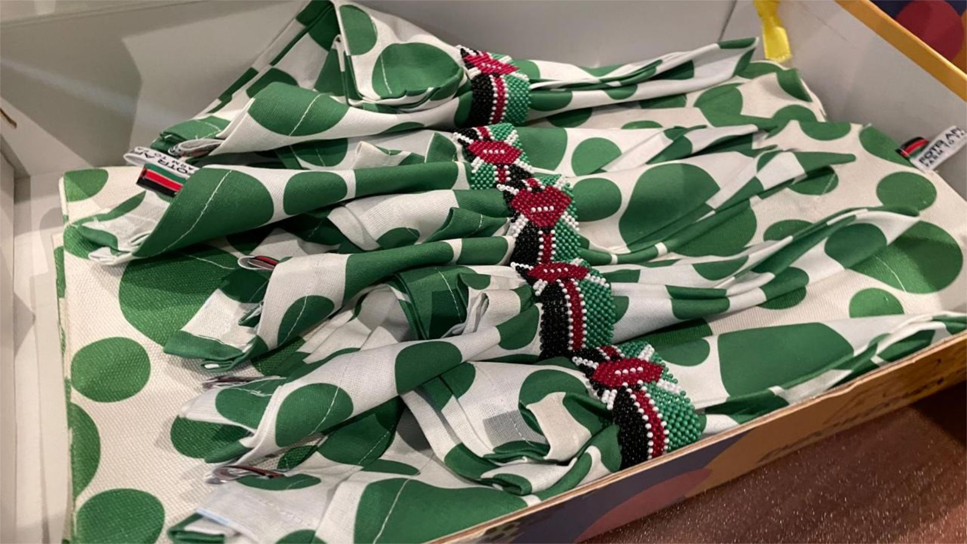 Textiles featuring beaded trims in Kenyan colours
