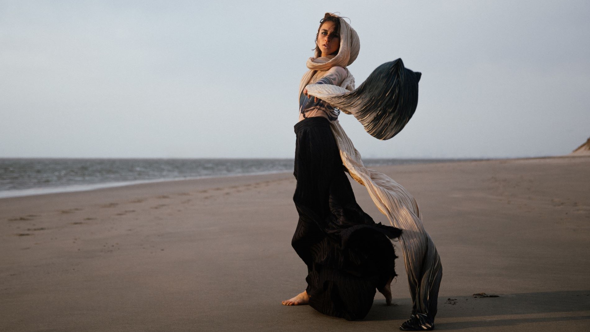 Model with flowing scarf on the beach