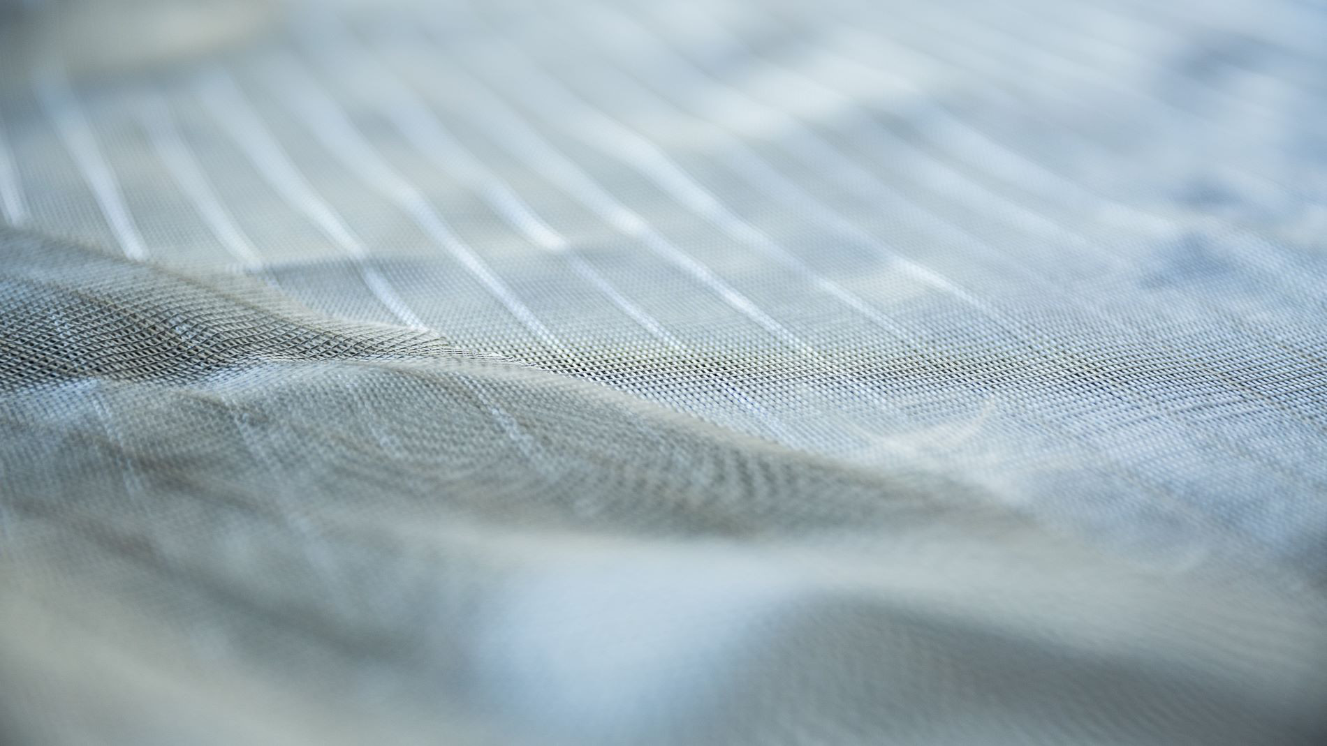 Close-up of pale blue woven fabric texture