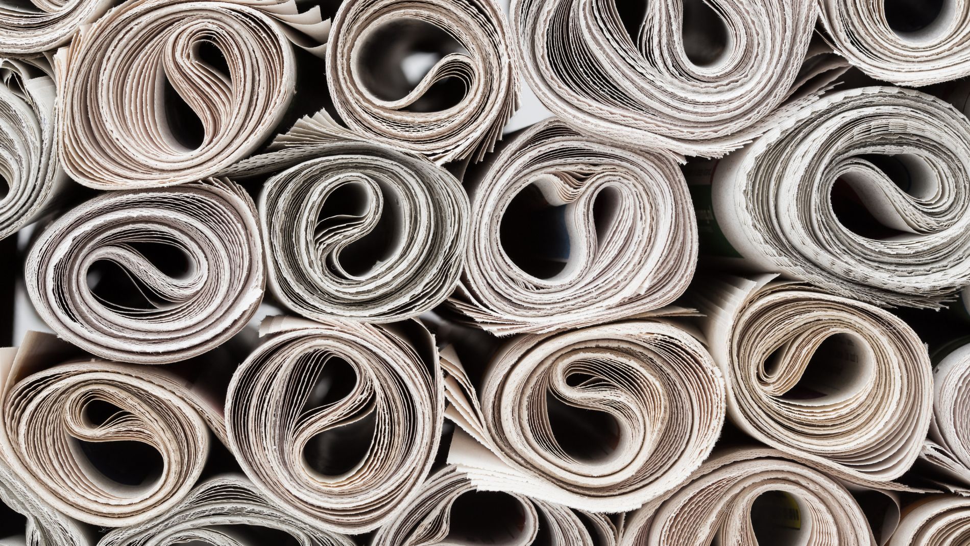 A pile of rolled-up newspapers