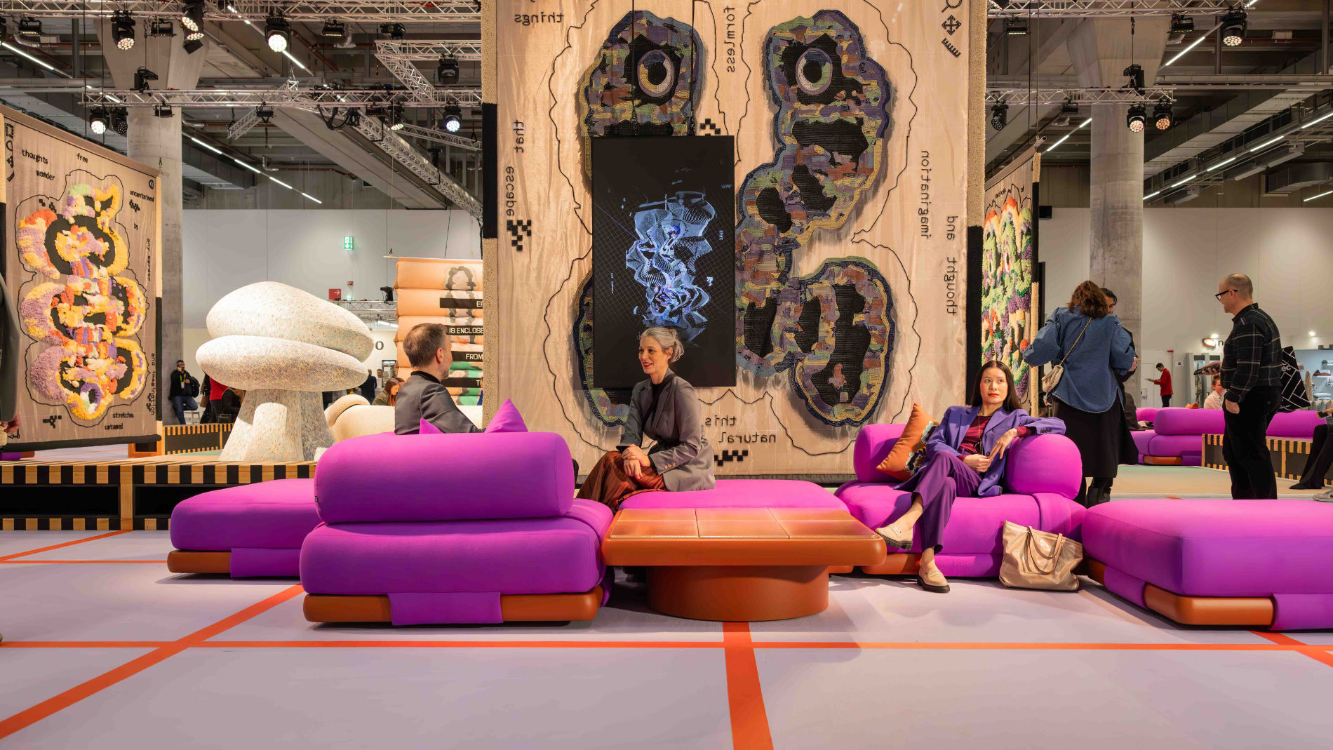 People sitting on modern pink sofas